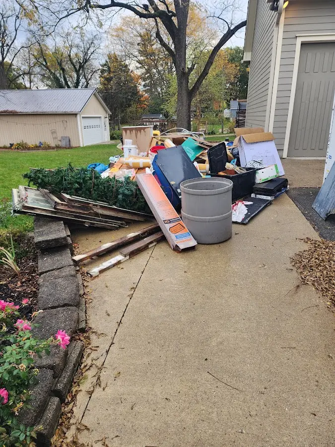 Dumpster being loaded with debris for 30 Yard Dumpster Rental in Benton Harbor